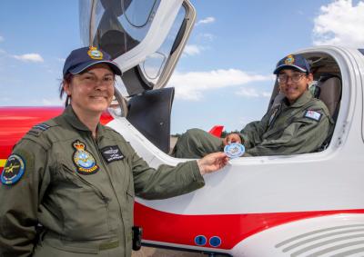 Picture of Flight Lieutenant Cathy Hobson from the Australian Air Force Cadets (AAFC) congratulates AAFC Cadet Corporal Adil Shaikh with his Solo Power Flight patch after his first solo flight in a Diamond DA40 NG Star aircraft at RAAF Base Richmond, New South Wales.
