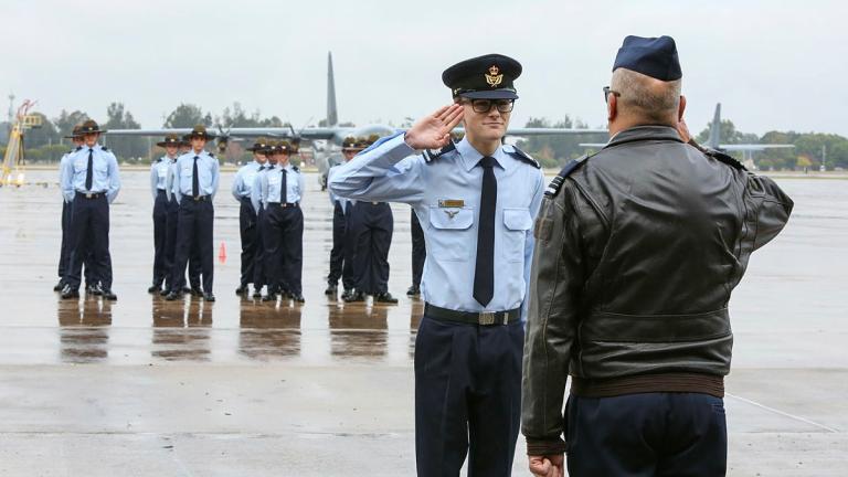 Cadet Warrant Officer Damon Cooke salutes Squadron Leader Bill Gleeson-Barker during 3WG drill competition