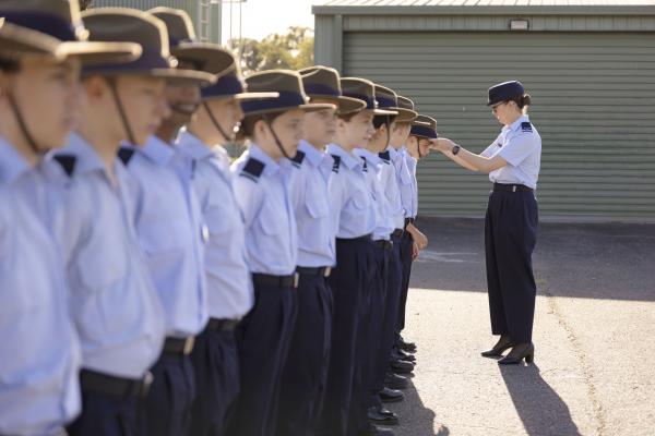 Staff Member adjusting hat on parade