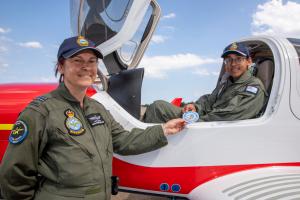 Picture of Flight Lieutenant Cathy Hobson from the Australian Air Force Cadets (AAFC) congratulates AAFC Cadet Corporal Adil Shaikh with his Solo Power Flight patch after his first solo flight in a Diamond DA40 NG Star aircraft at RAAF Base Richmond, New South Wales.